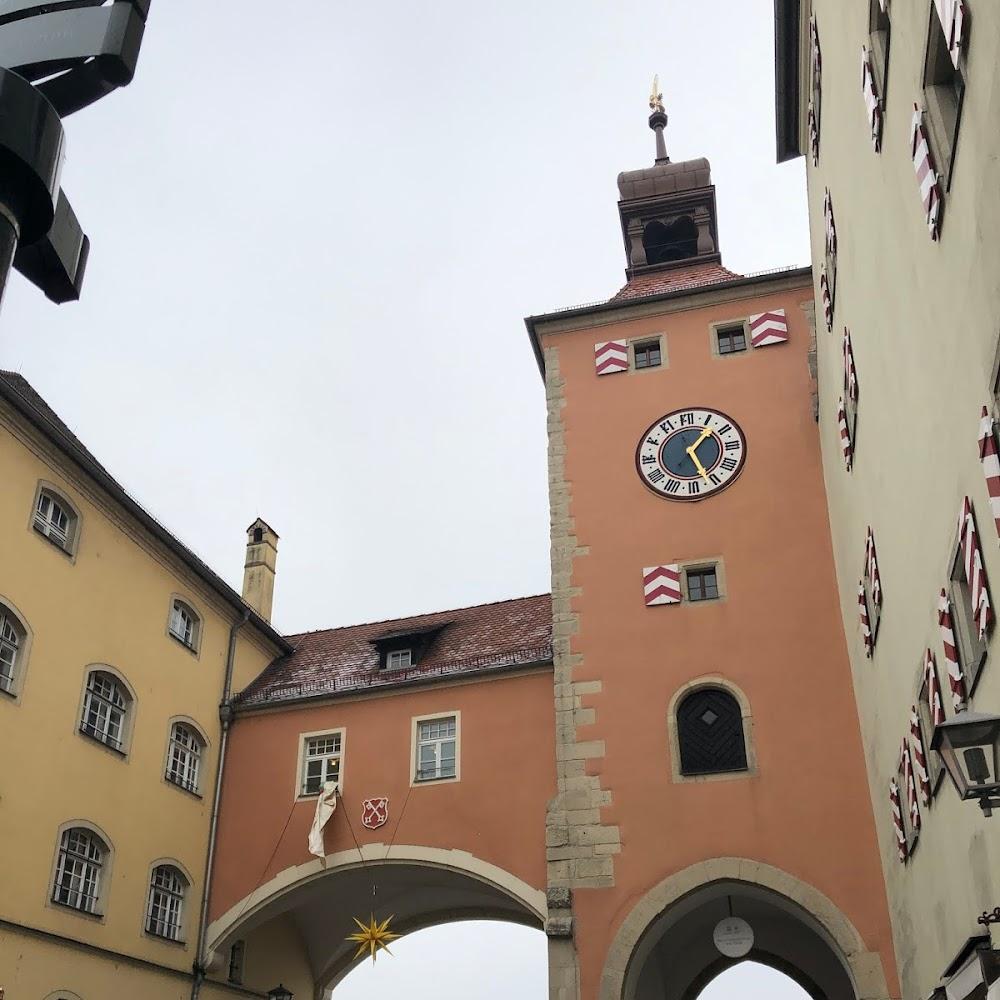 Clock tower with an arched gateway.  Landmark:  Augsburg Town Hall.